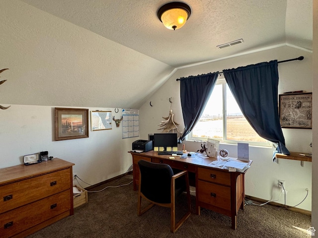 office featuring vaulted ceiling, visible vents, a textured ceiling, and carpet floors