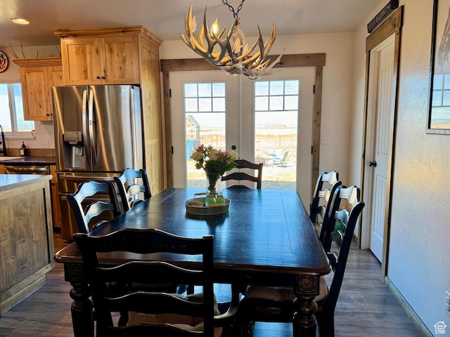 dining room with baseboards, a chandelier, and dark wood-type flooring