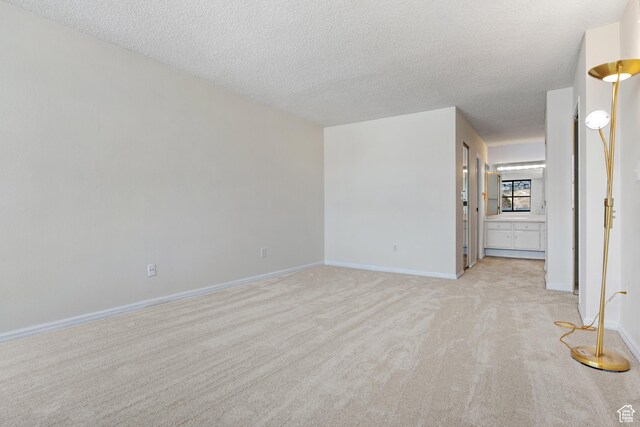 241 N Vine St W Unit 1101E, Salt Lake City, UT 84103 - carpeted spare room with a textured ceiling