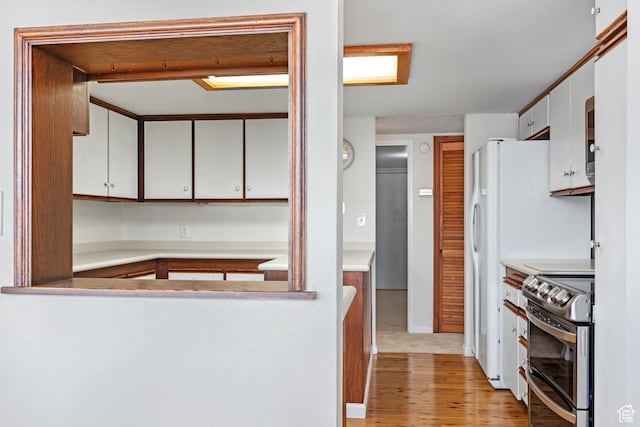 241 N Vine St W Unit 1101E, Salt Lake City, UT 84103 - kitchen featuring stainless steel range with electric stovetop, light hardwood / wood-style flooring, and white cabinets