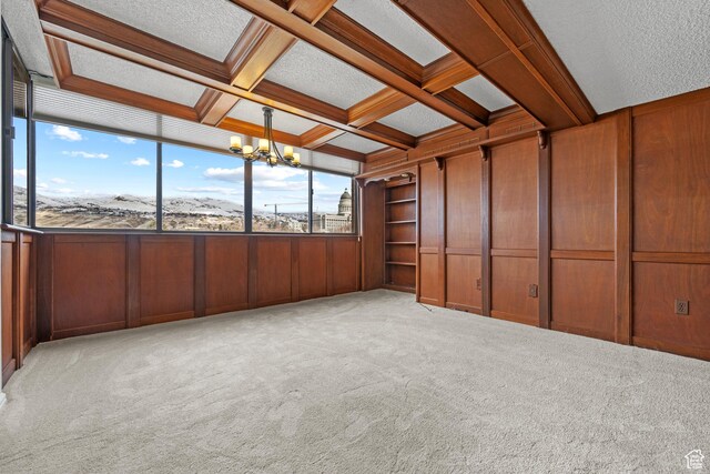 241 N Vine St W Unit 1101E, Salt Lake City, UT 84103 - unfurnished sunroom featuring beamed ceiling, coffered ceiling, and an inviting chandelier