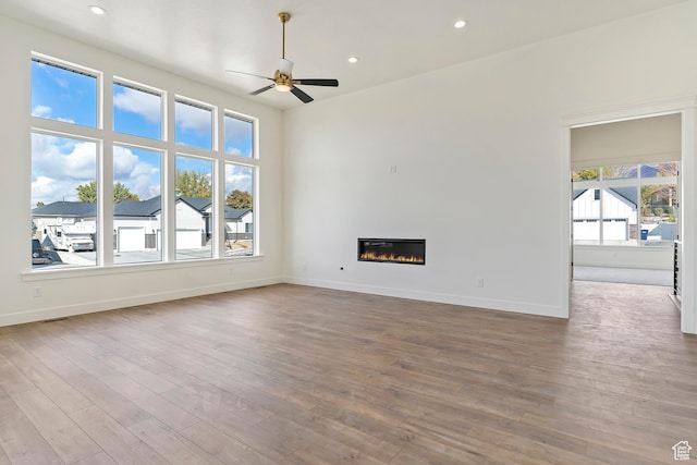 434 W 450 S Unit 815, Farmington, UT 84025 - unfurnished living room with a ceiling fan, wood finished floors, recessed lighting, and a glass covered fireplace
