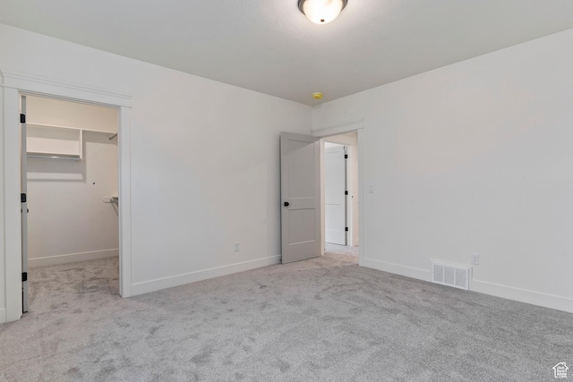 434 W 450 S Unit 815, Farmington, UT 84025 - unfurnished bedroom featuring carpet flooring and a walk in closet