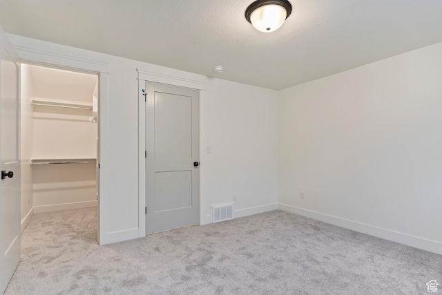 434 W 450 S Unit 815, Farmington, UT 84025 - unfurnished bedroom with carpet flooring, a spacious closet, a closet, and a textured ceiling