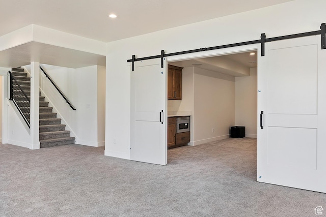 434 W 450 S Unit 815, Farmington, UT 84025 - unfurnished living room with a barn door, light colored carpet, stairs, and recessed lighting