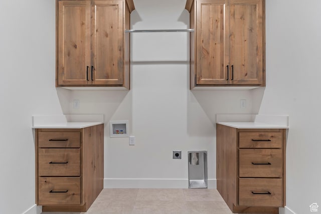 434 W 450 S Unit 815, Farmington, UT 84025 - laundry area featuring cabinet space, washer hookup, electric dryer hookup, and light tile patterned floors