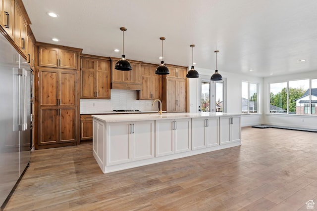 434 W 450 S Unit 815, Farmington, UT 84025 - kitchen with built in fridge, stovetop, light wood-style floors, recessed lighting, and light countertops