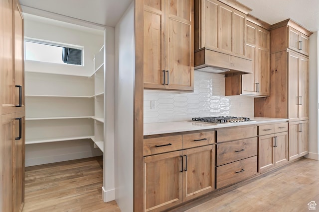 434 W 450 S Unit 815, Farmington, UT 84025 - kitchen featuring stainless steel gas cooktop, light wood-type flooring, tasteful backsplash, and light countertops