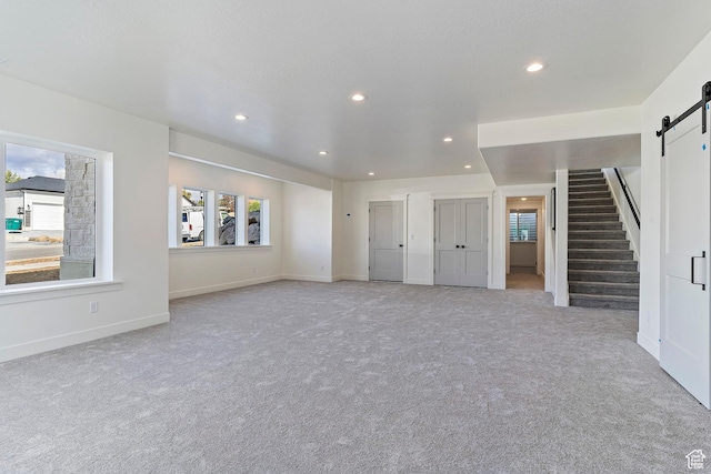 434 W 450 S Unit 815, Farmington, UT 84025 - unfurnished living room featuring a barn door, carpet flooring, recessed lighting, and stairway