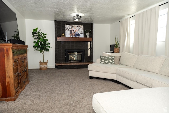 living area with a textured ceiling, a fireplace, baseboards, and carpet flooring