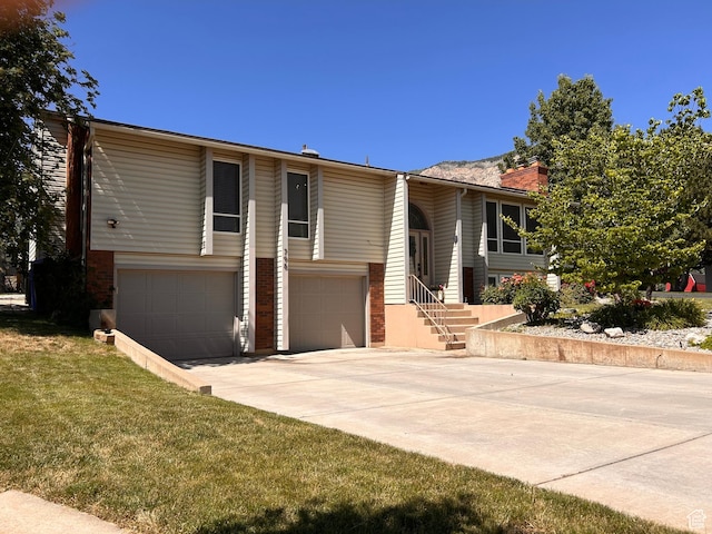798 E 2800 N, North Ogden, UT 84414 - view of front of property with an attached garage, concrete driveway, a chimney, and a front yard