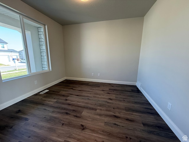 5523 N Honey Suckle Way, Eagle Mountain, UT 84005 - empty room with dark wood finished floors and baseboards
