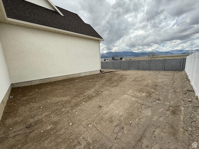 5523 N Honey Suckle Way, Eagle Mountain, UT 84005 - fenced backyard featuring a mountain view