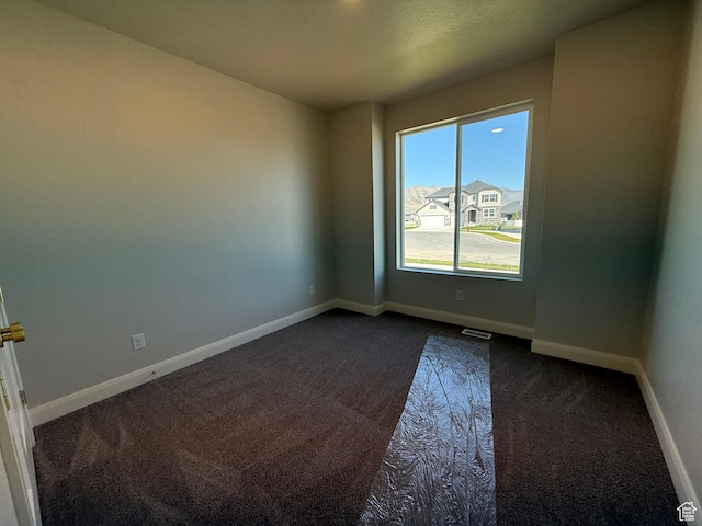 5523 N Honey Suckle Way, Eagle Mountain, UT 84005 - empty room with dark carpet and baseboards