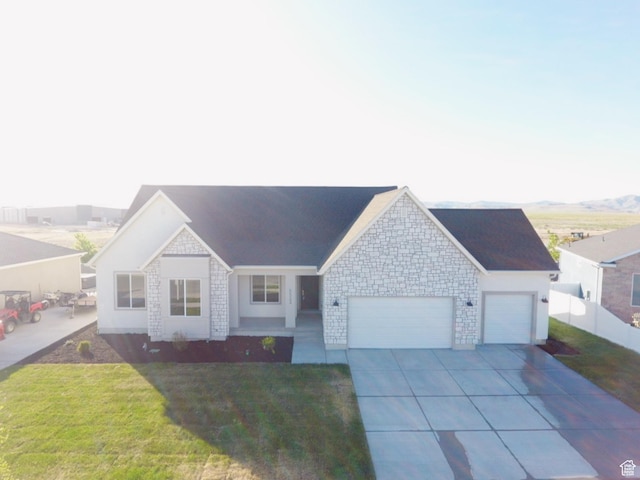 5523 N Honey Suckle Way, Eagle Mountain, UT 84005 - ranch-style house with a garage, driveway, and stone siding