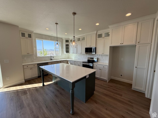 5523 N Honey Suckle Way, Eagle Mountain, UT 84005 - kitchen featuring appliances with stainless steel finishes, baseboards, dark wood-type flooring, white cabinets, and recessed lighting