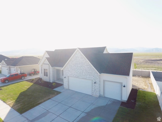 5523 N Honey Suckle Way, Eagle Mountain, UT 84005 - ranch-style house with a garage, stone siding, and concrete driveway