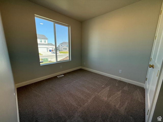 5523 N Honey Suckle Way, Eagle Mountain, UT 84005 - empty room featuring dark carpet and baseboards