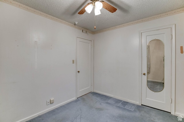 carpeted empty room with ceiling fan and a textured ceiling
