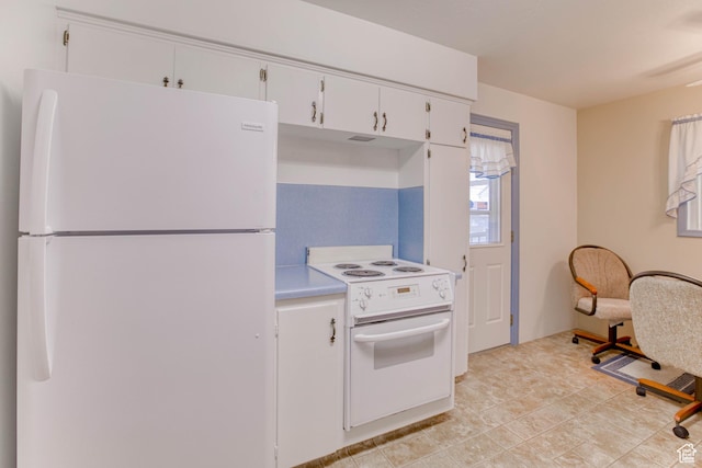 kitchen featuring white appliances and white cabinets
