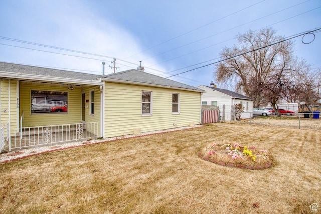 rear view of house with a lawn