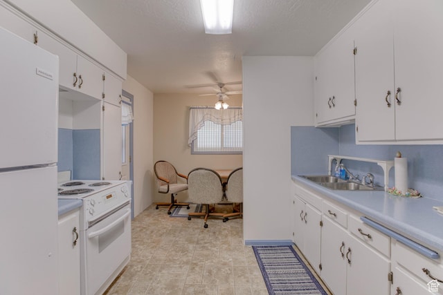 kitchen featuring white cabinetry, white appliances, sink, and a textured ceiling