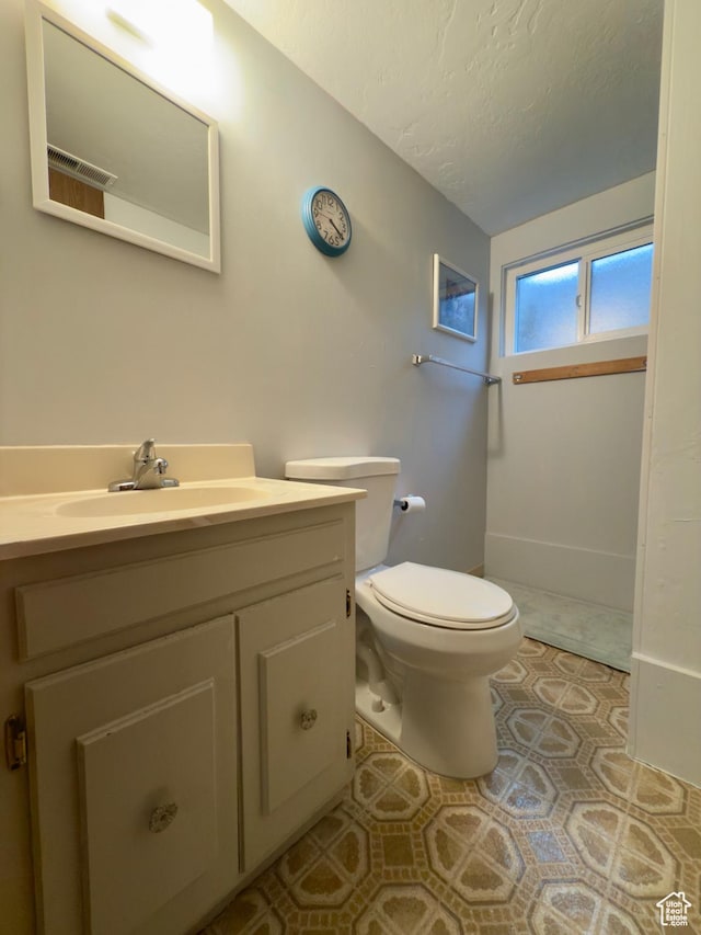 1460 E Amalfi Ave, Sandy, UT 84093 - bathroom with toilet, vanity, and a textured ceiling