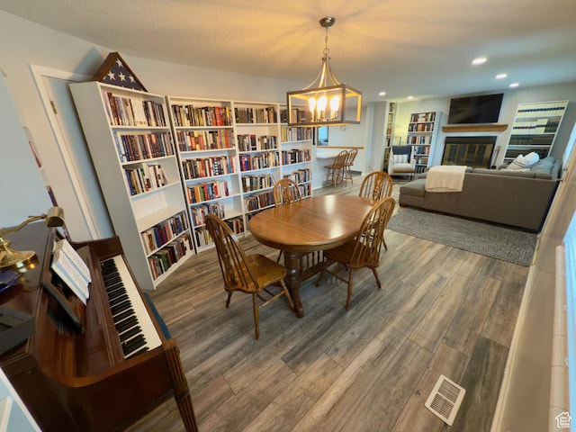 1460 E Amalfi Ave, Sandy, UT 84093 - dining room with wood finished floors, a chandelier, a tile fireplace, and recessed lighting