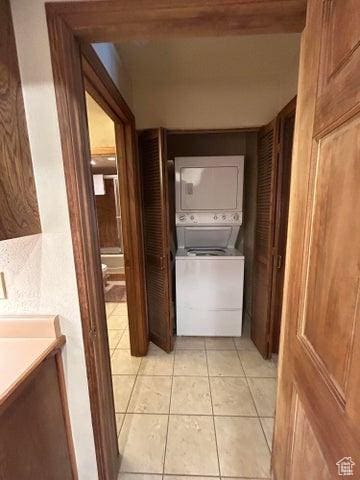 150 W Ridgeview St Unit 213, Brian Head, UT 84719 - hallway featuring stacked washer and dryer and light tile patterned flooring