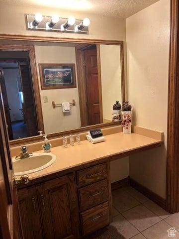 150 W Ridgeview St Unit 213, Brian Head, UT 84719 - bathroom with tile patterned flooring, vanity, and a textured ceiling