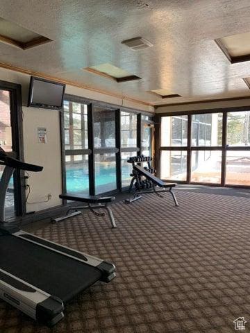 150 W Ridgeview St Unit 213, Brian Head, UT 84719 - exercise room with a textured ceiling and dark carpet