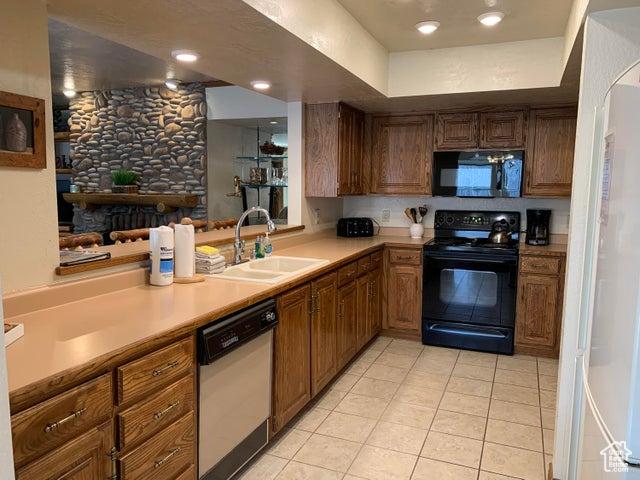 150 W Ridgeview St Unit 213, Brian Head, UT 84719 - kitchen featuring light tile patterned flooring, kitchen peninsula, sink, and black appliances