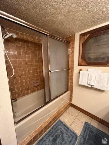 150 W Ridgeview St Unit 213, Brian Head, UT 84719 - bathroom with tile patterned flooring, shower / bath combination with glass door, and a textured ceiling