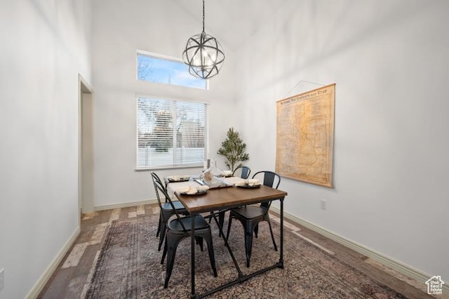 1952 E Meadow Downs Way, Cottonwood Heights, UT 84121 - dining space with baseboards, a high ceiling, an inviting chandelier, and wood finished floors