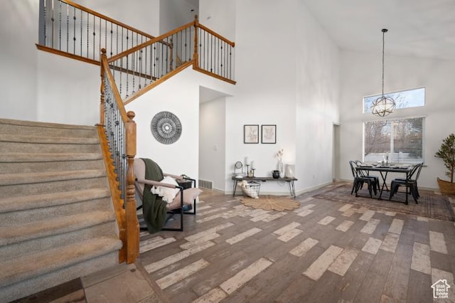 1952 E Meadow Downs Way, Cottonwood Heights, UT 84121 - foyer entrance featuring baseboards, stairs, a high ceiling, an inviting chandelier, and wood finished floors