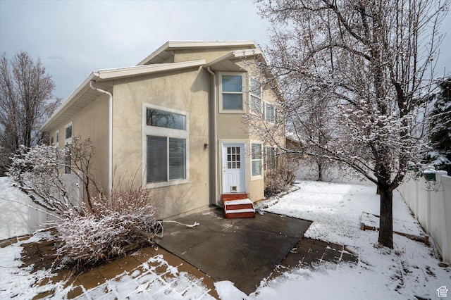 1952 E Meadow Downs Way, Cottonwood Heights, UT 84121 - snow covered house featuring stucco siding, a fenced backyard, and entry steps