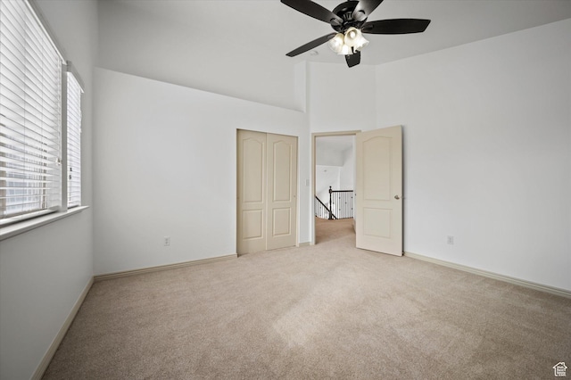 1952 E Meadow Downs Way, Cottonwood Heights, UT 84121 - unfurnished bedroom with baseboards, light carpet, a high ceiling, and a closet