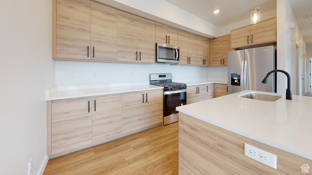 1266 S Sawmill Blvd Unit 3-303, Heber City, UT 84032 - kitchen featuring hanging light fixtures, light hardwood / wood-style flooring, sink, appliances with stainless steel finishes, and light brown cabinetry