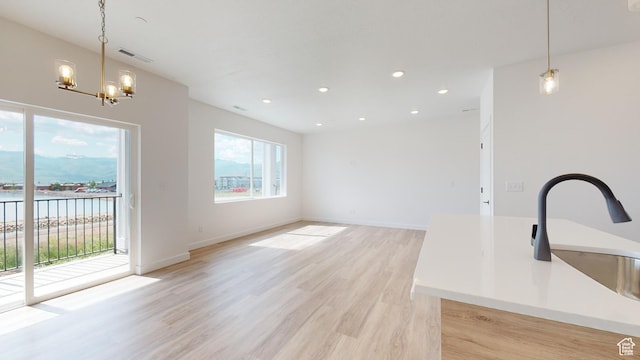 1266 S Sawmill Blvd Unit 3-303, Heber City, UT 84032 - interior space with a notable chandelier, a water view, sink, and light wood-type flooring