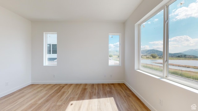 1266 S Sawmill Blvd Unit 3-303, Heber City, UT 84032 - unfurnished room with light hardwood / wood-style floors and a water and mountain view