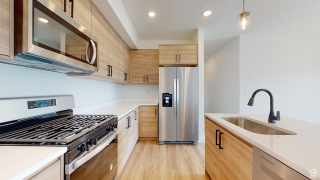 1266 S Sawmill Blvd Unit 3-303, Heber City, UT 84032 - kitchen featuring stainless steel appliances, decorative light fixtures, light hardwood / wood-style floors, sink, and light brown cabinetry