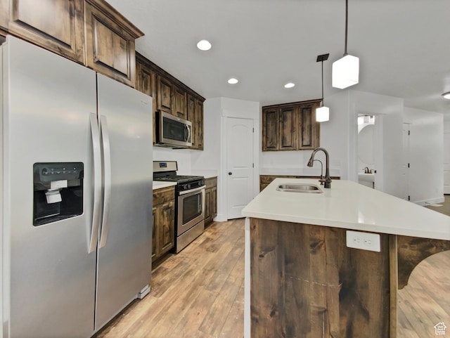 4961 W Longboat Ln, Herriman, UT 84096 - kitchen featuring sink, appliances with stainless steel finishes, a kitchen island with sink, and hanging light fixtures