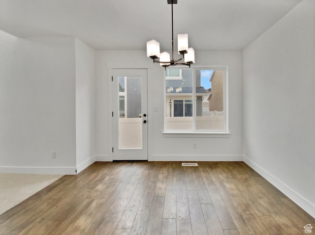 4961 W Longboat Ln, Herriman, UT 84096 - unfurnished dining area with hardwood / wood-style floors and an inviting chandelier
