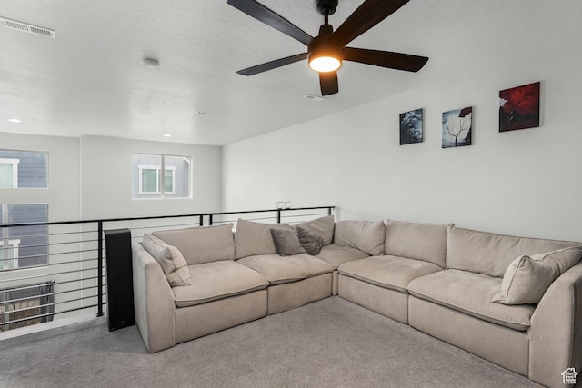 carpeted living room featuring a textured ceiling