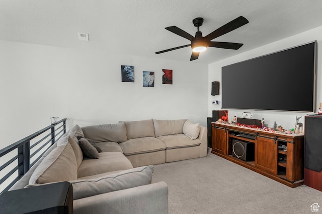 living room with light carpet, ceiling fan, and a textured ceiling