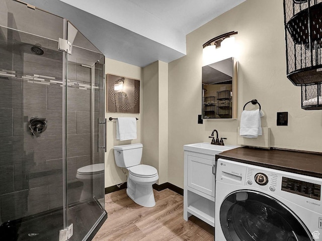 2015 Prospector Ave Unit 106, Park City, UT 84060 - bathroom with walk in shower, hardwood / wood-style floors, toilet, vanity, and washer / dryer