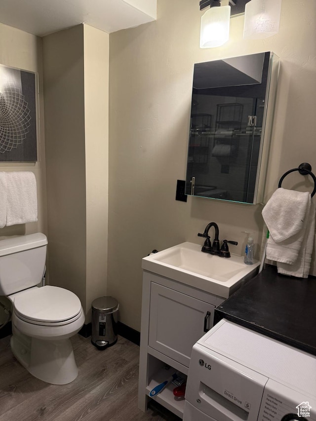2015 Prospector Ave Unit 106, Park City, UT 84060 - bathroom featuring hardwood / wood-style flooring, washer / clothes dryer, vanity, and toilet