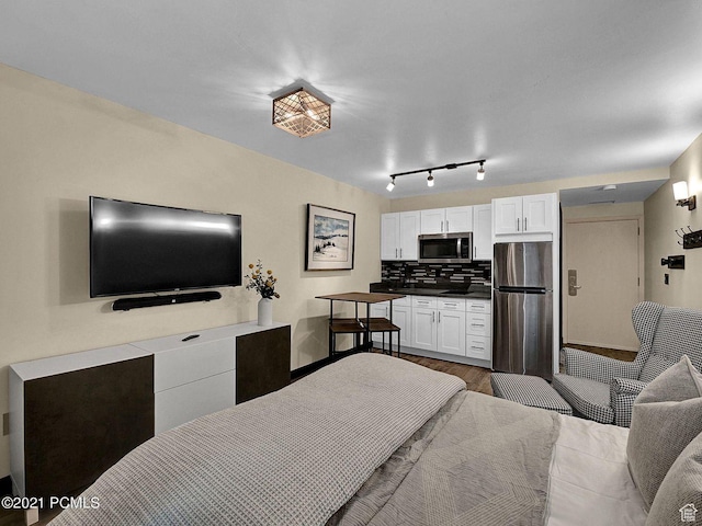 2015 Prospector Ave Unit 106, Park City, UT 84060 - bedroom featuring wood-type flooring and stainless steel refrigerator