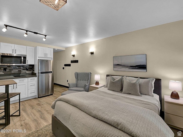 2015 Prospector Ave Unit 106, Park City, UT 84060 - bedroom with light hardwood / wood-style flooring and stainless steel refrigerator