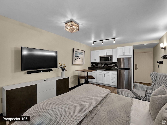 2015 Prospector Ave Unit 106, Park City, UT 84060 - bedroom featuring hardwood / wood-style flooring and stainless steel refrigerator
